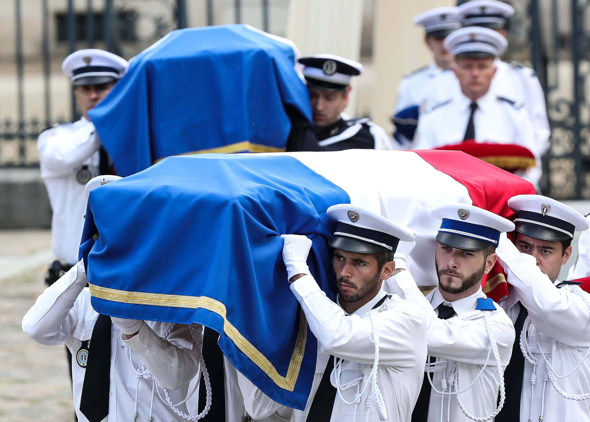 Image of French police officers carrying the coffins of the two officers who were shot dead.