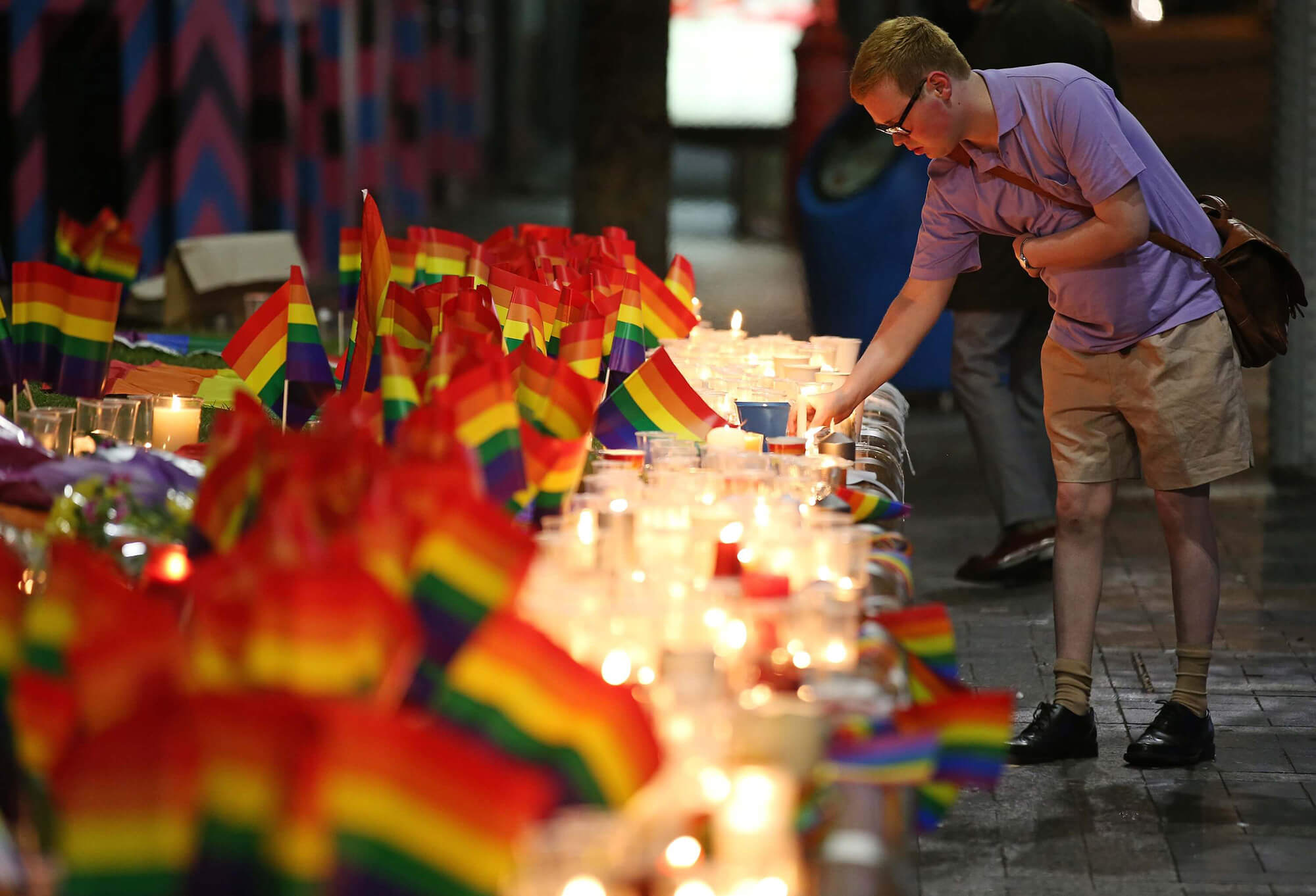 LGBT+ flags with candles as a memorial to the victims of the Orlando mass shooting