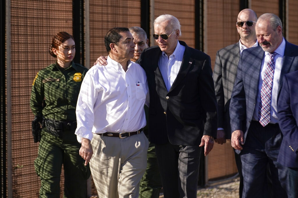 President Joe Biden talks with Rep. Henry Cuellar, D-Texas, second from left, as they walk along a stretch of the U.S.-Mexico border in El Paso Texas, Sunday, Jan. 8, 2023.