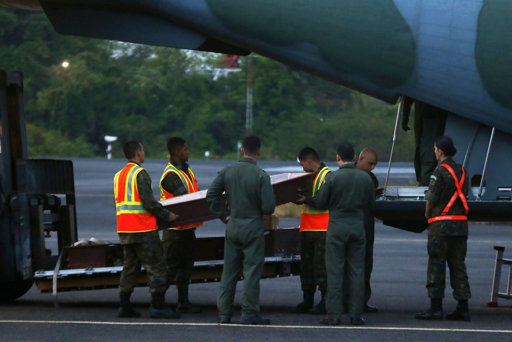 Soldiers load empty coffins into a military transport airplane, for the victims of a plane crash, in Manaus, Brazil, Sunday, Sept. 17, 2023.