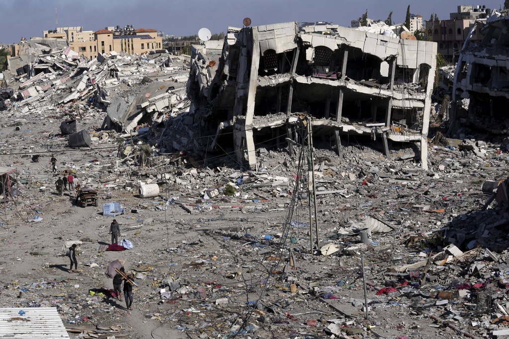Palestinians visit their houses destroyed in the Israeli bombings in Al-Zahra, on the outskirts of Gaza City, on Thursday, Nov. 30, 2023. during the temporary ceasefire between Hamas and Israel.