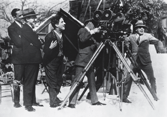 Chaplin on location shooting The Gold Rush while in tramp regalia.