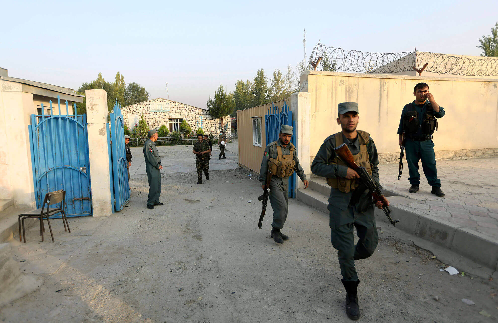 Afghan security forces inspect the site after an attack on the American University of Afghanistan in Kabul, Afghanistan