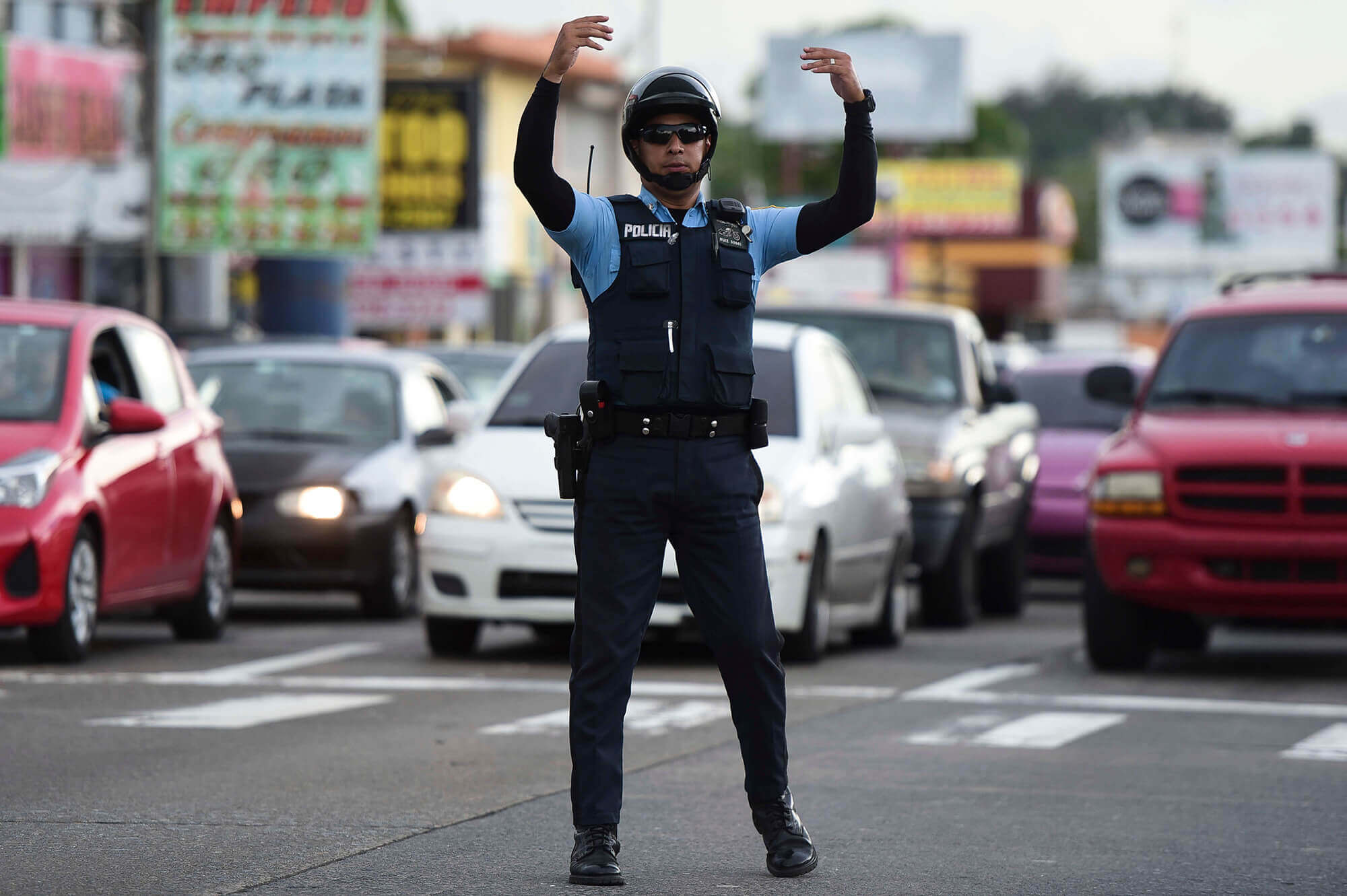Image of Puerto Rican police officer directing traffic in blackout