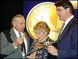 Image of Sen. Ben Campbel w/ Philip Diehl and Glenna Goodacre Holding New Sacagawea Dollar Coin