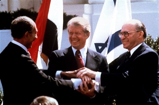 President Carter symbolic handshake with Sadat and Begin