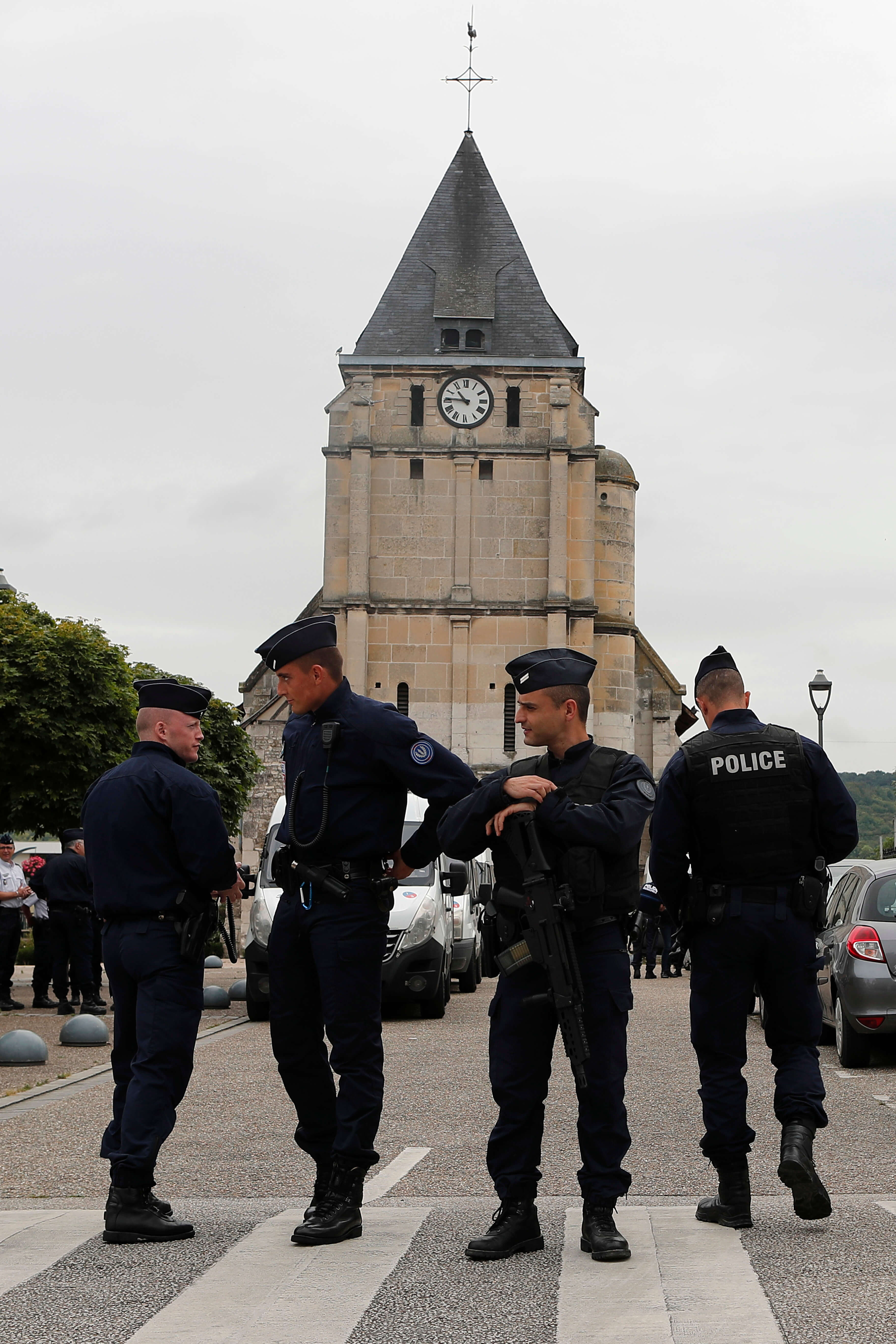 Image of French police officers standing in front of the church in Normandy