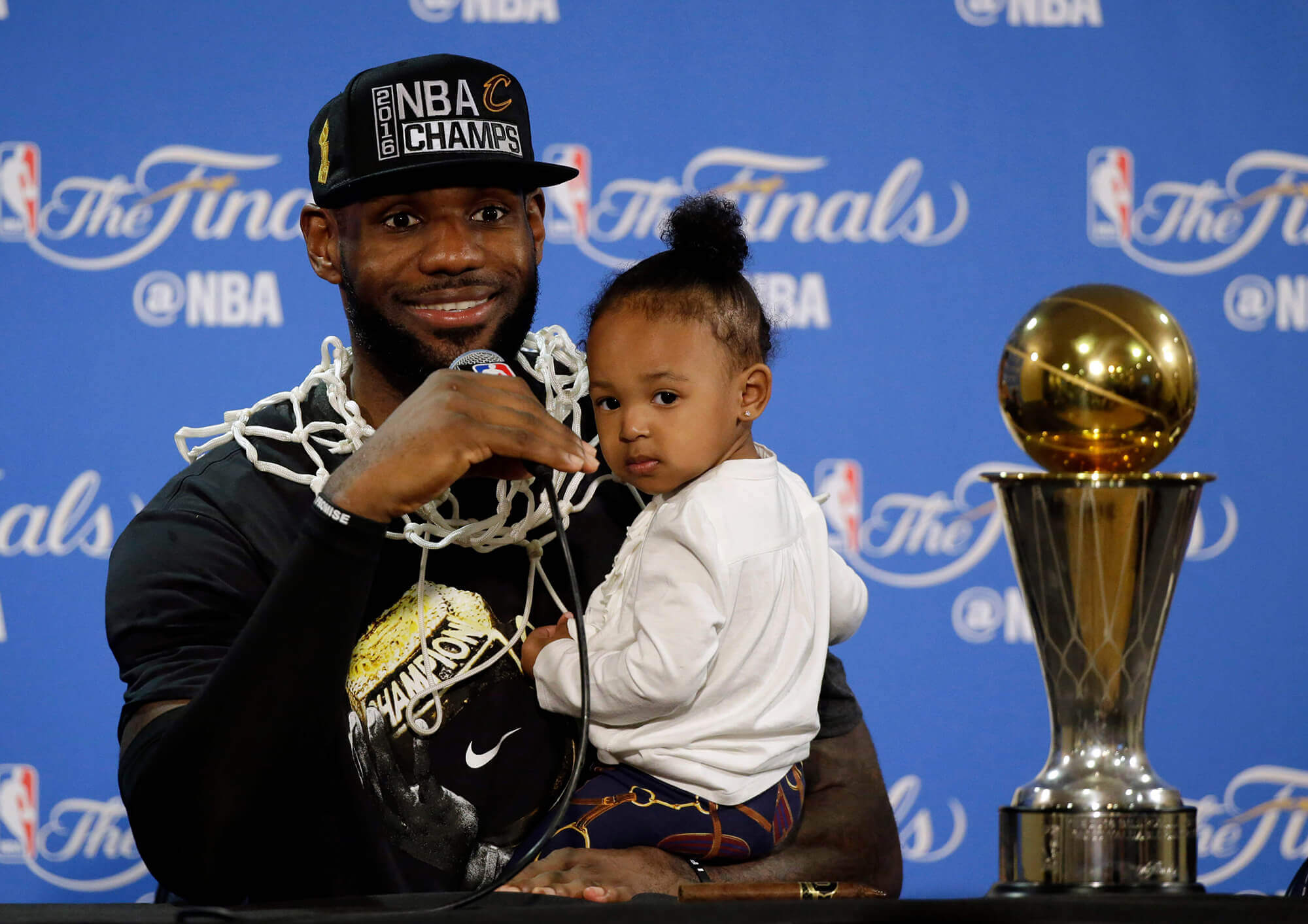 LeBron James with his daughter and the MVP trophy