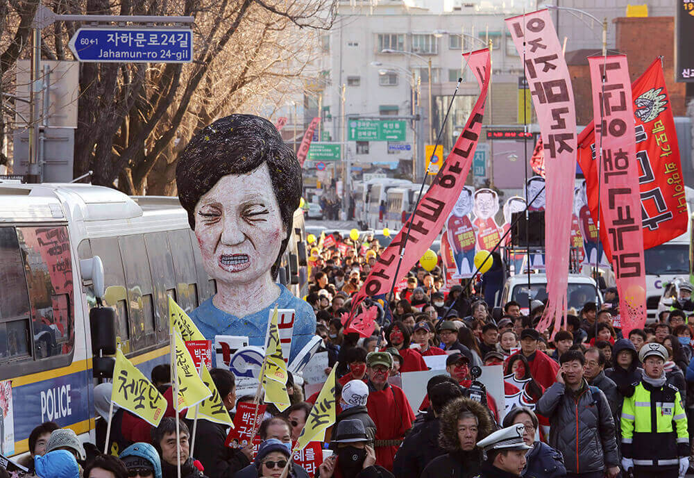 Image of protesters with an effigy of South Korean President Park Geun-hye