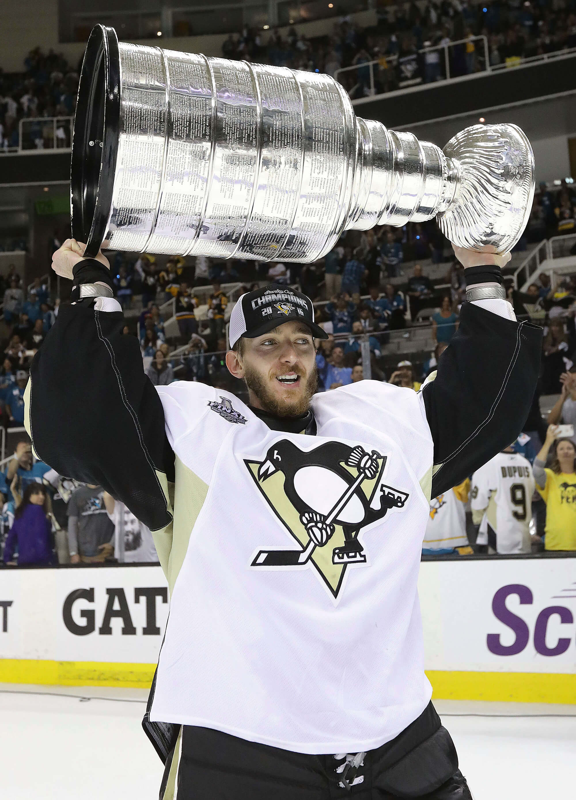 Pittsburgh Penguin player with Stanley Cup after victory