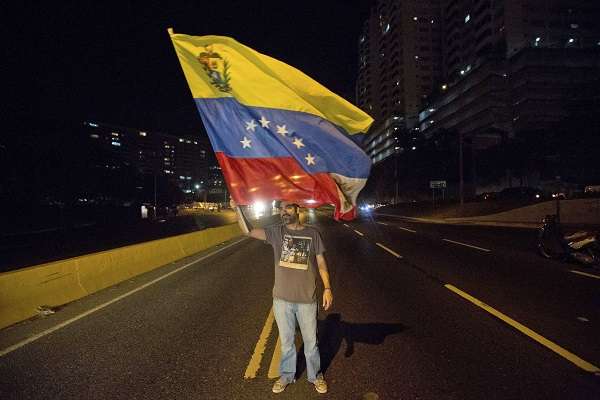 Protestor Waves a Venezuelan Flag