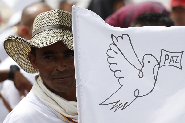 Former FARC Rebel Holds a Sign with a Dove