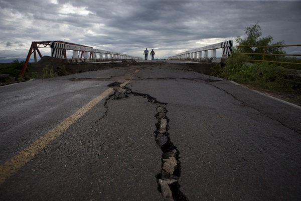 Men Cross a Damaged Bridge in Chiapas