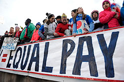 Equal Pay Supporters Holding Banner
