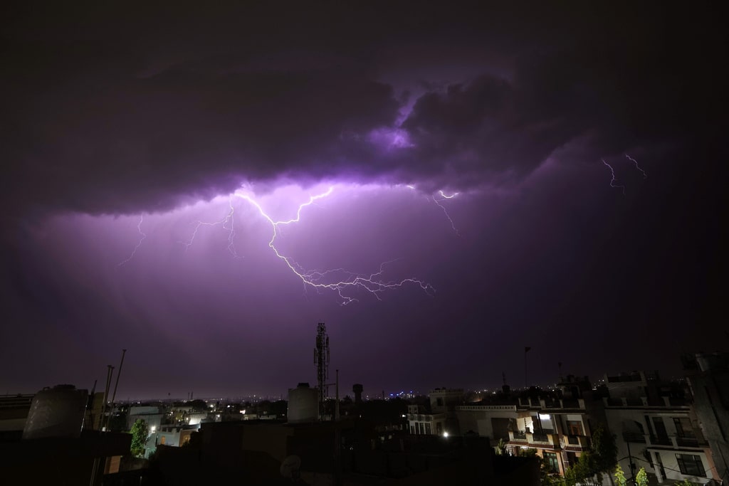 A bolt of lighting strikes over in Jammu, India, Thursday, April20, 2023. 