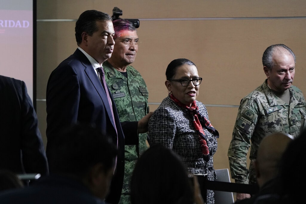 Mexican Public Safety Secretary Rosa Icela Rodriguez, center, and Mexican Defense Secretary Luis Cresencio Sandoval, back left, leave after giving a news conference announcing the arrest of Ovidio in Mexico City