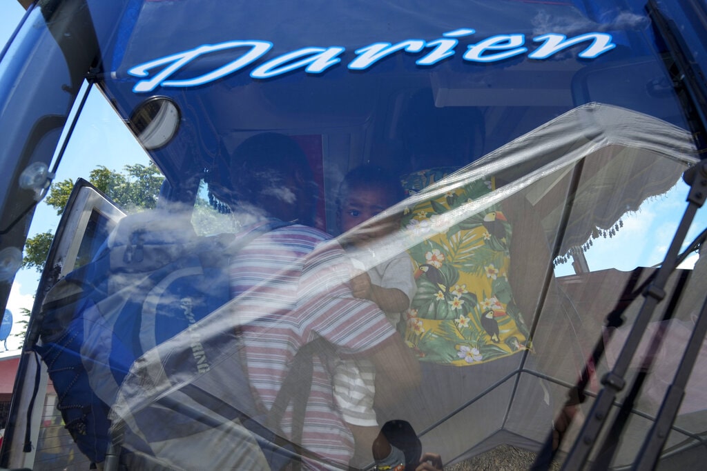 IMAGEMigrants, many from from Haiti, board a bus that will transport them to another shelter on their journey through Panama, trying to reach the United States, in Lajas Blancas, Darien province, Panama, Friday, Oct. 1, 2021