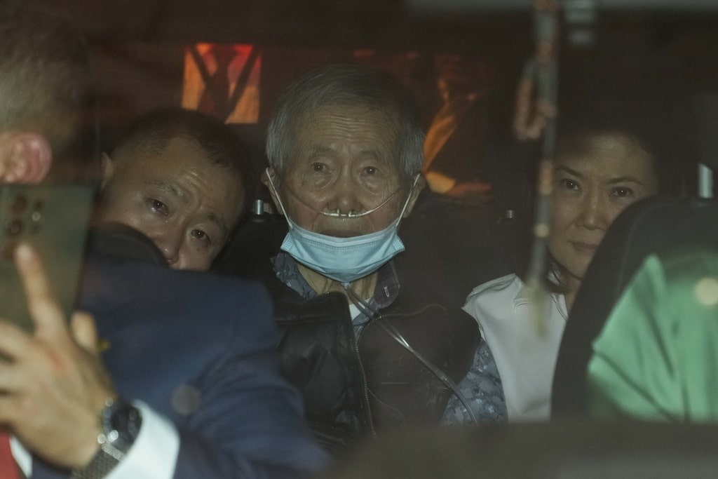Peru's former President Alberto Fujimori, 85, center, is driven away from a prison by one of his lawyers, accompanied by his son Kenji, left, and daughter Keiko, after his release in Callao, Peru, Wednesday, Dec. 6, 2023.
