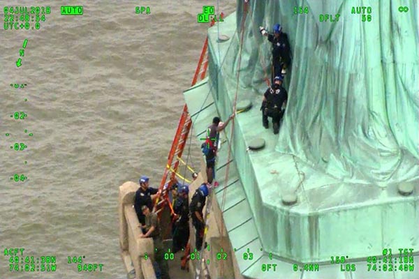 Woman Climbs Statue of Liberty