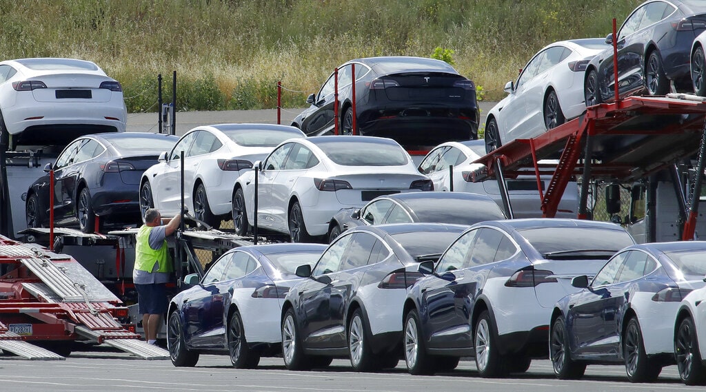 Tesla cars are loaded onto carriers at the Tesla electric car plant on May 13, 2020, in Fremont, Calif. Tesla is recalling nearly 363,000 vehicles with its “Full Self-Driving” system to fix problems with the way it behaves around intersections and following posted speed limits, the National Highway Traffic Safety Administration announced Thursday, Feb. 16, 2023.