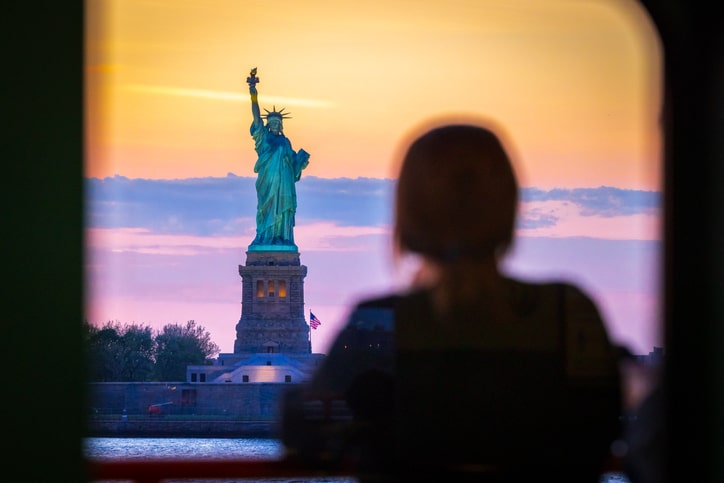 Woman watches the Statue of Liberty