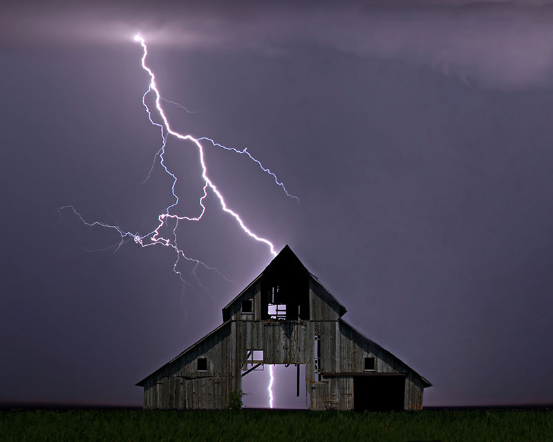 lightning over an abandoned farmhouse