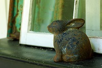 metal rabbit in front of window