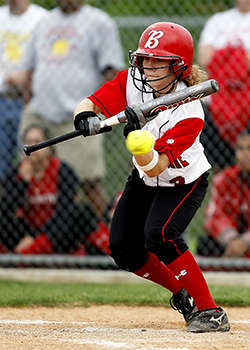 Staying safe while playing on the field - young woman playing softball