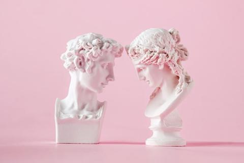 gypsum antique bust of man and woman on pink background, concept of love trust and valentine's day