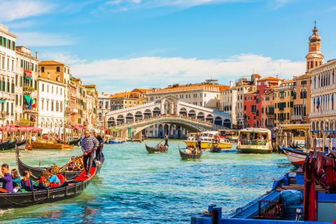 Panoramic view of the Grand Canal with gondolas and the Rialto Bridge. Venice, Italy