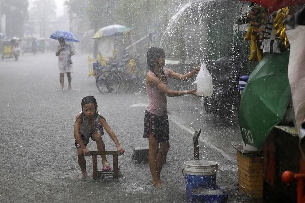 Children play despite the rain